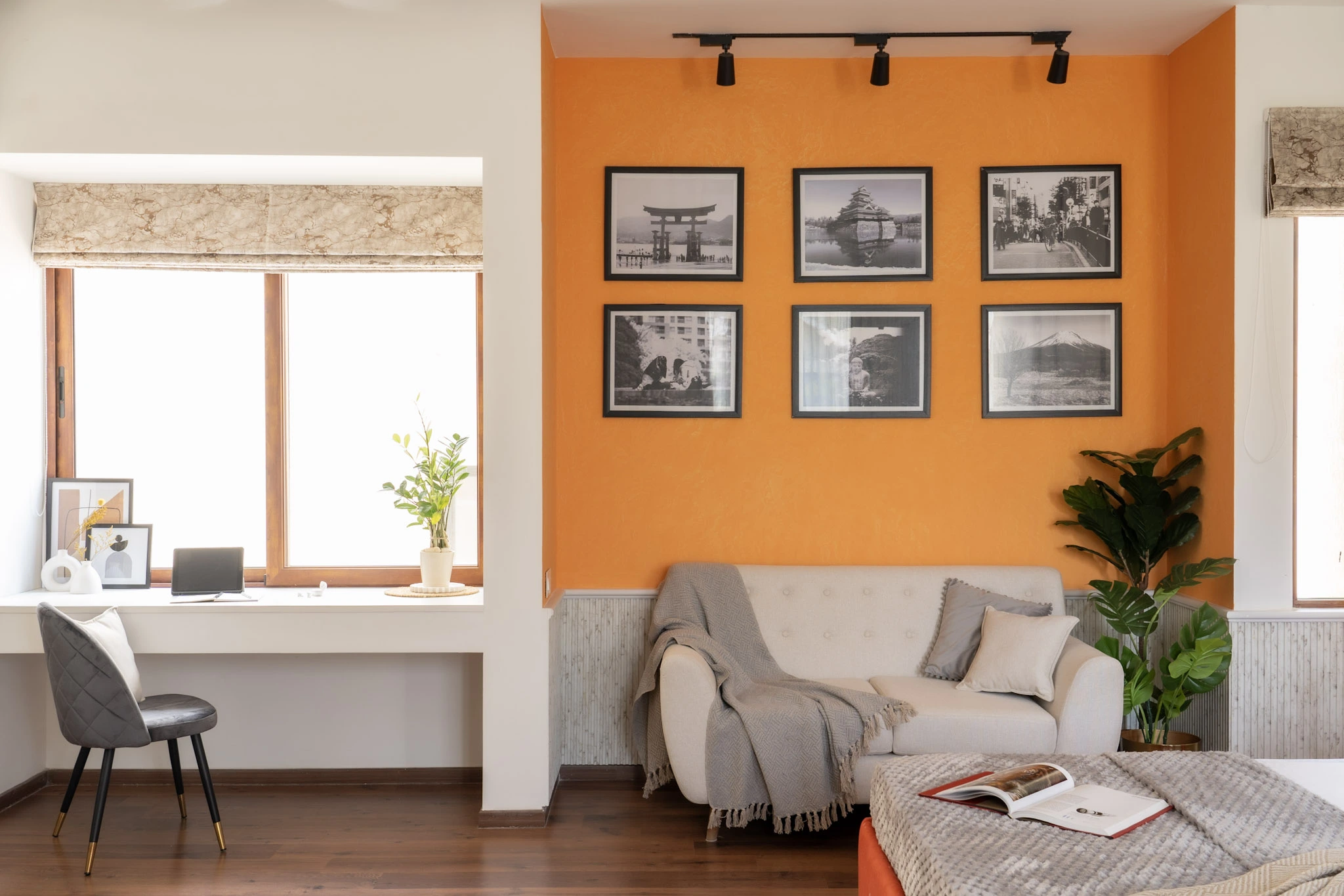 Modern bedroom interior with orange accent wall, reading nook, workspace, and contemporary décor