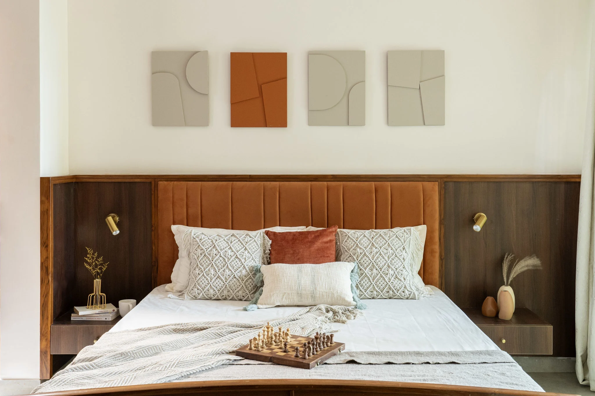 Modern bedroom with upholstered headboard, wooden furniture and minimalist wall art