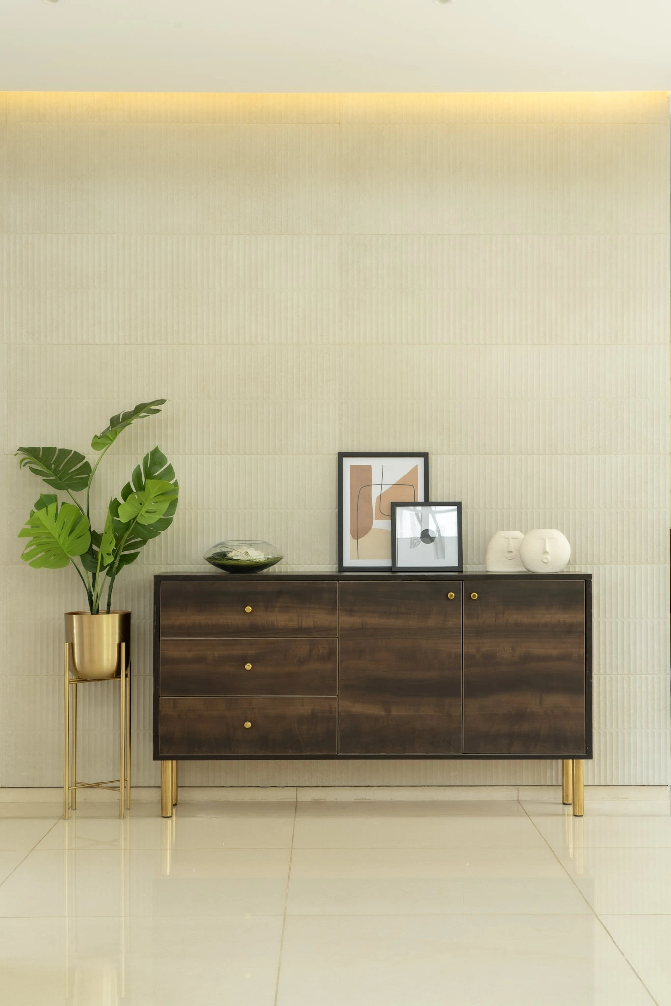 Modern luxury villa foyer with wooden console unit, textured wall design, indoor plants, and warm ambient lighting