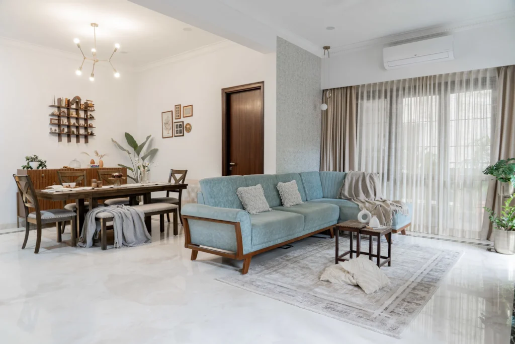 Contemporary living room design with blue sofa and large windows