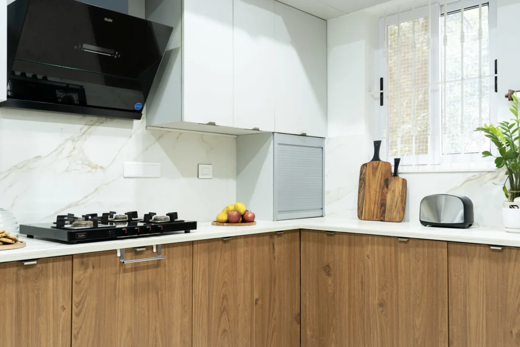 Serene Haven modular kitchen with wood cabinets by House of Crea